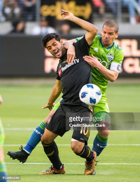 Carlos Vela of Los Angeles FC battles Osvaldo Alonso of Seattle Sounders during Los Angeles FC's MLS match against Seattle Sounders at the Banc of...