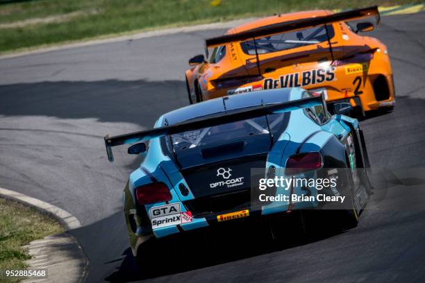 The Mercedes AMG GT3 of Daniel Morad, of Canada, and Fabian Schiller, of Germany, leads the Bentley Continental GT3 of Rodrigo Baptista, of Brazil ,...