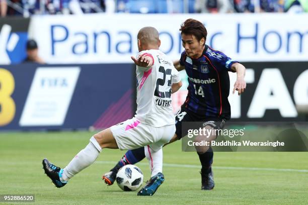 Koki Yonekura of Gamba Osaka takes on Yutaka Yoshida of Sagan Tosu during the J.League J1 match between Gamba Osaka and Sagan Tosu at Suita City...