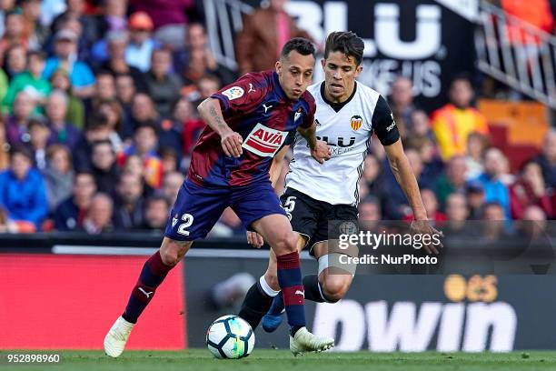 Fabian Orellana of SD Eibar competes for the ball with Gabriel Paulista of Valencia CF during the La Liga game between Valencia CF and SD Eibar at...