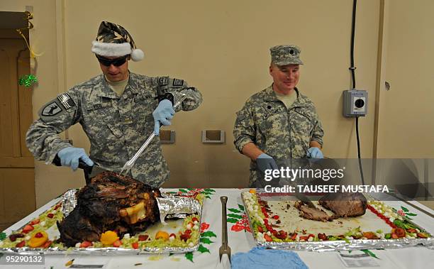 Army officers serve lunch to US soldiers on Christmas day at a military camp in Nuristan Province on December 25, 2009. Afghan President Hamid Karzai...