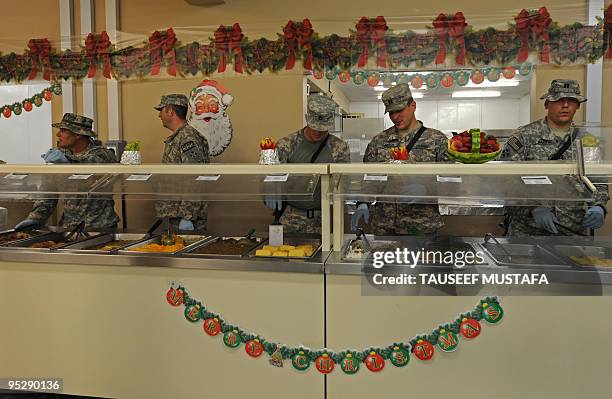 Army officers serve lunch to US soldiers on Christmas day at a military camp in Nuristan Province on December 25, 2009. Afghan President Hamid Karzai...