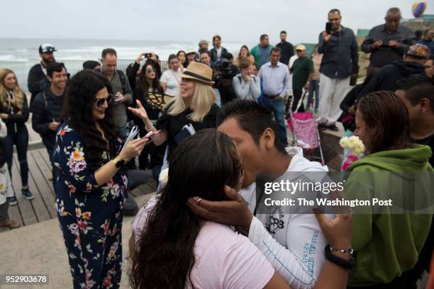 William Rafael Carranza Martinez kisses Teresa de Jesus Leiba Cordado during their wedding, which was with three other couples from the group, before...