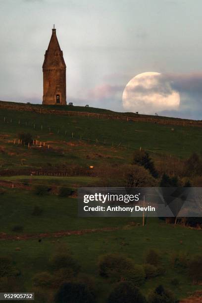 The Pink Moon rises beside Hartshead Pike on April 29, 2018 in Manchester, England. The tower was rebuilt in 1863 by John Eaton to commemorate the...