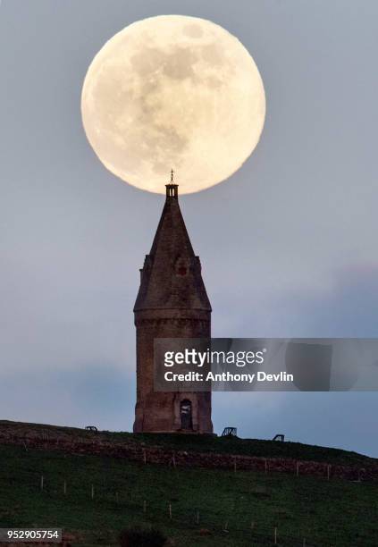 The Pink Moon rises beside Hartshead Pike on April 29, 2018 in Manchester, England. The tower was rebuilt in 1863 by John Eaton to commemorate the...