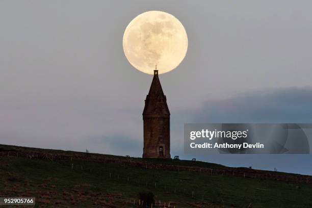 The Pink Moon rises beside Hartshead Pike on April 29, 2018 in Manchester, England. The tower was rebuilt in 1863 by John Eaton to commemorate the...