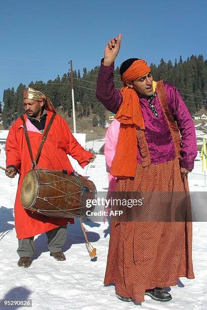 Kashmiri folk artists perform during a snow festival in Indian administered Kashmir's key ski-resort of Gulmarg on December 25, 2009. Hundreds of...