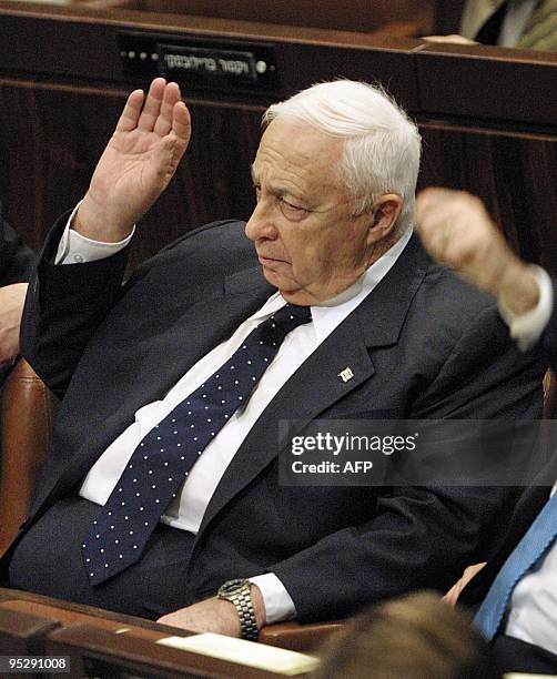 Israeli Prime Minister Ariel Sharon votes on the economic austerity plan during the full Knesset plenum in Jerusalem 28 May 2003. The plan is aimed...