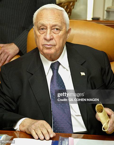 Israeli Prime Minister Ariel Sharon opens the weekly cabinet meeting at his office in Jerusalem 25 May 25 2003. Sharon convened his cabinet for a...