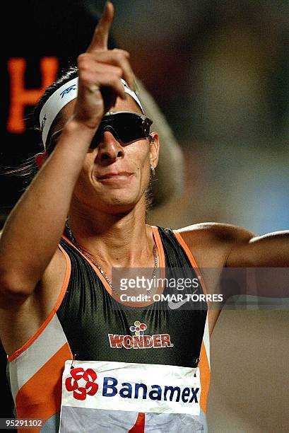 Mexican Ana Guevara reacts after crossing the finish line in the 300 meter race to set a new world record with a time of 35.30, 03 May 2003, during...