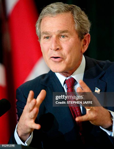 President George W. Bush gestures in a joint press conference with British Prime Minister Tony Blair at Hillsborough Castle 08 April 2003 near...