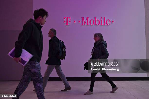 Shoppers walk through the lobby of a T-Mobile US Inc. Store in Chicago, Illinois, U.S., on Friday, Oct. 21, 2016. T-Mobile US Inc. Agreed to acquire...