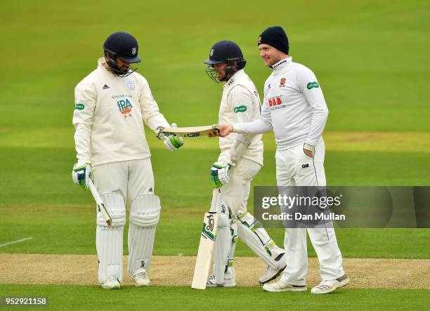 Sam Cook of Essex hands Rilee Rossouw of Hampshire his broken bat during day four of the Specsavers County Championship Division One match between...