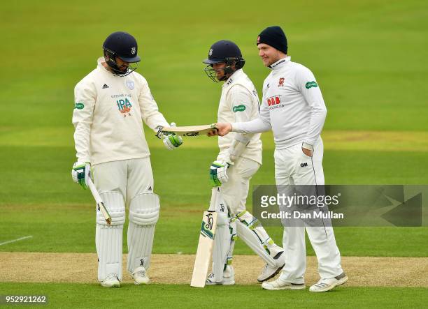 Sam Cook of Essex hands Rilee Rossouw of Hampshire his broken bat during day four of the Specsavers County Championship Division One match between...