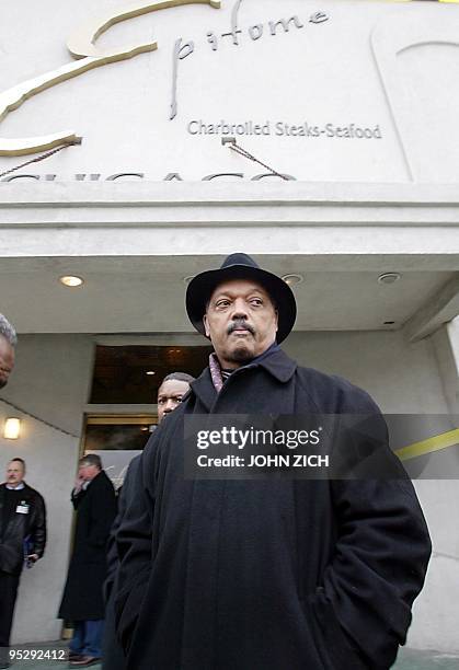 Rev Jesse Jackson stands outside the "Epitome" night club 17 February, 2003 where twenty-one people were killed and dozens more injured in a stampede...