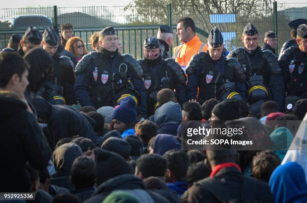 Refugees and migrants wait to leave the Jungle during the evacuation. The Jungle was an illegal migrant camp in the northern French town of Calais....