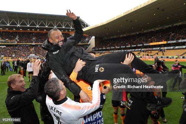 Nuno Espirito Santo, Manager of Wolverhampton Wanderers is carried across the pitch after winning the Sky Bet Championship during the Sky Bet...