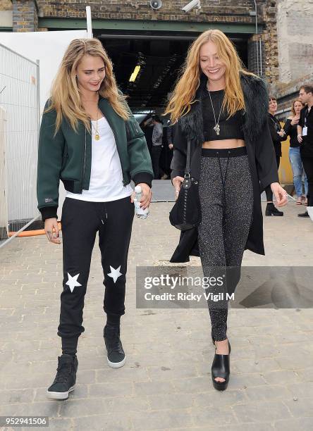 Cara Delevingne and Clara Paget attend the Topshop Unique show during London Fashion Week on September 14, 2014 in London, England.