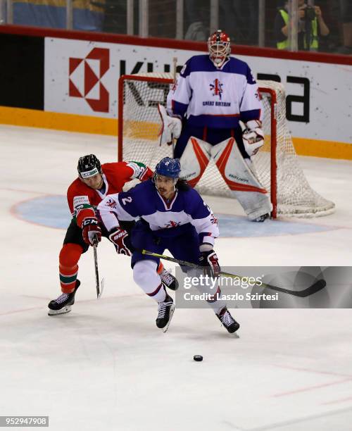 Csanad Erdely of Hungary challenges Dallas Ehrhardt of Great Britain in front of Ben Bowns of Great Britain during the 2018 IIHF Ice Hockey World...