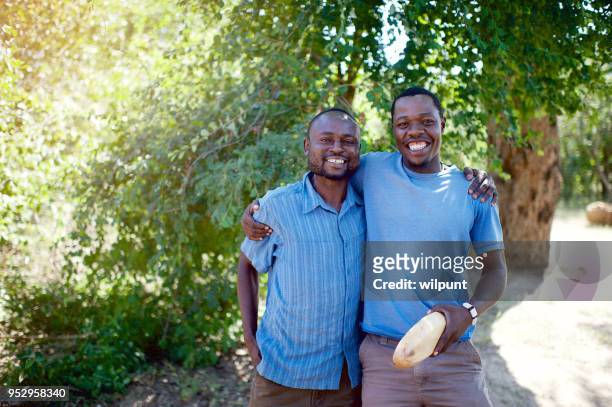 business friends standing together under a tree - zimbabwe stock pictures, royalty-free photos & images