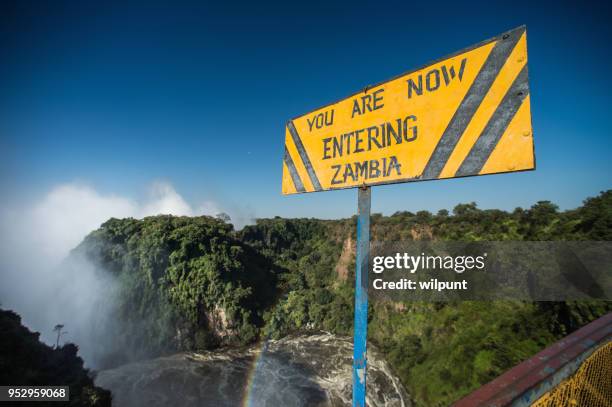 entering zambia sign above the zambezi - victoria falls stock pictures, royalty-free photos & images