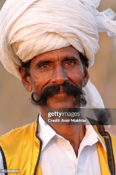 mature man with huge (big) mustaches participating in tent pegging (sports activity) - picchetto da tenda foto e immagini stock