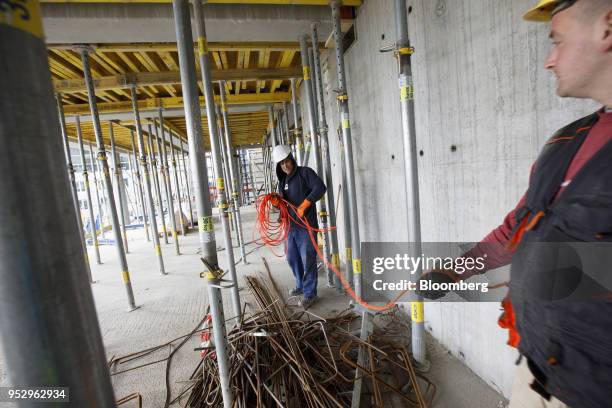 Construction workers uncoil electrical cables as building work continues on the Omiturm mixed-use 45-story residential and office tower block,...