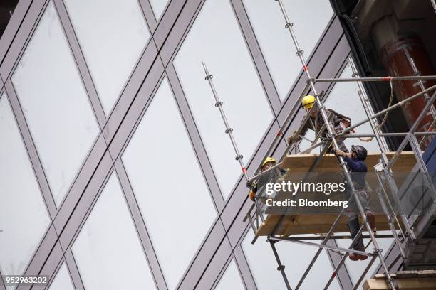 Construction workers assemble a scaffolding platform as building work continues on the Omiturm mixed-use 45-story residential and office tower block,...