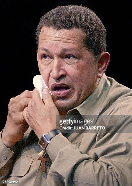 President Hugo Chávez wipes his face as he announces that he will not step down despite the ongoing strike in Caracas, Venezuela 11 January 2003. El...