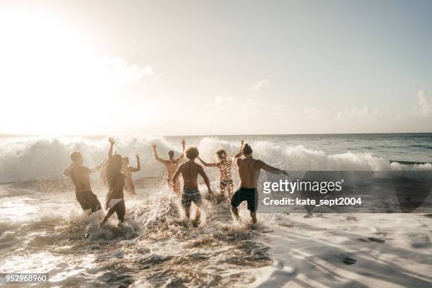 exciting beach activities. - beach party stock pictures, royalty-free photos & images