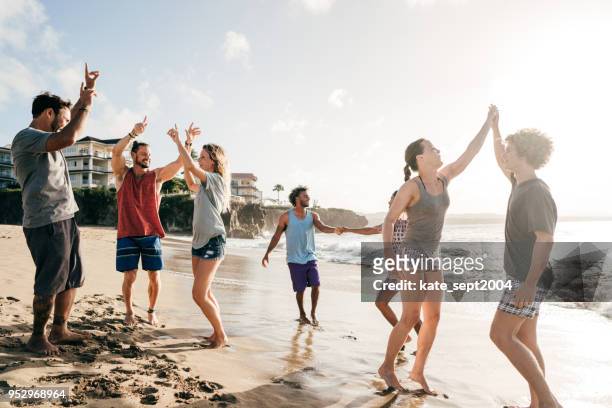 team building at the beach. - team building stock pictures, royalty-free photos & images