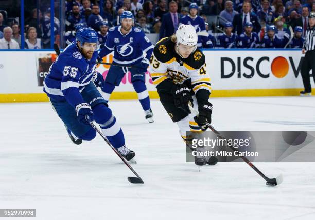Braydon Coburn of the Tampa Bay Lightning against Danton Heinen of the Boston Bruins during Game One of the Eastern Conference Second Round during...