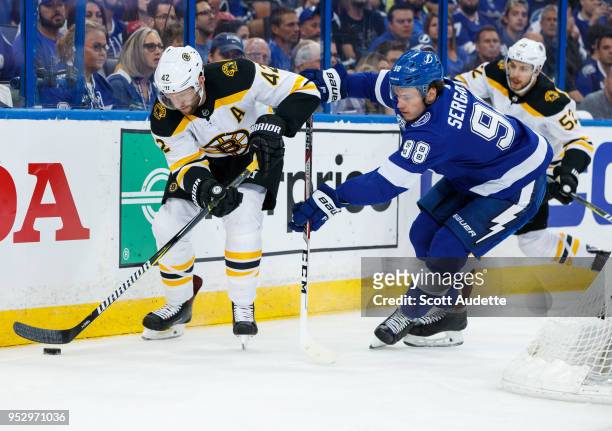 David Backes of the Boston Bruins skates against Mikhail Sergachev of the Tampa Bay Lightning during Game One of the Eastern Conference Second Round...