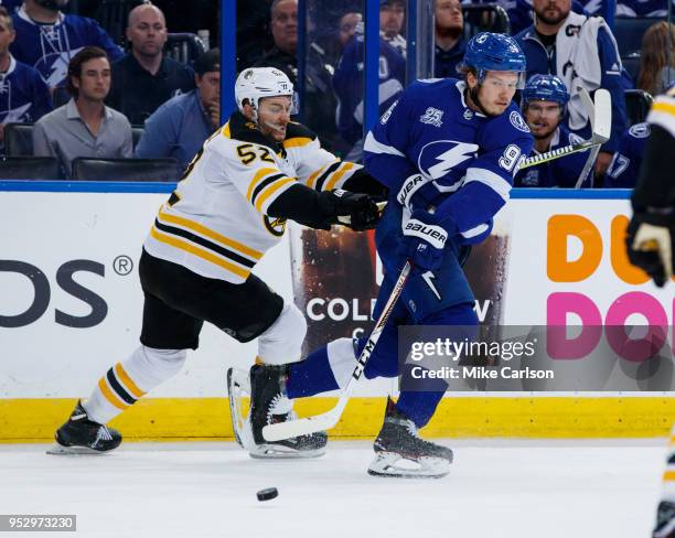 Mikhail Sergachev of the Tampa Bay Lightning against Sean Kuraly of the Boston Bruins during Game One of the Eastern Conference Second Round during...
