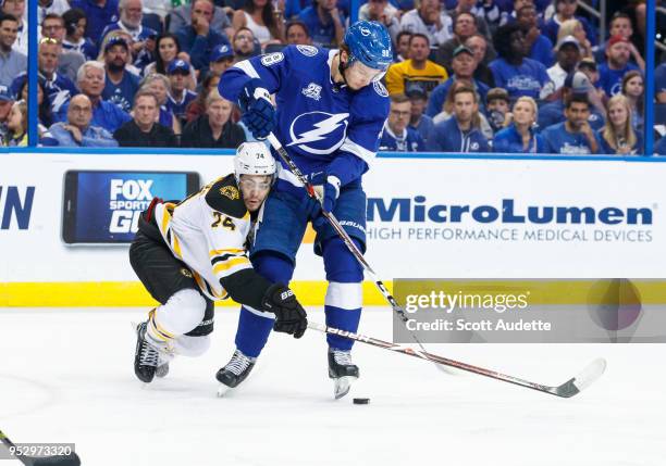 Mikhail Sergachev of the Tampa Bay Lightning against Jake DeBrusk of the Boston Bruins during Game One of the Eastern Conference Second Round during...