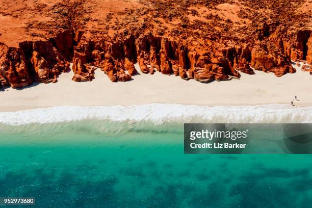 a helicopter view of the white sands, turquoise ocean and striking red kooljaman cliffs at cape leveque in western australia's north west. - australia occidental fotografías e imágenes de stock