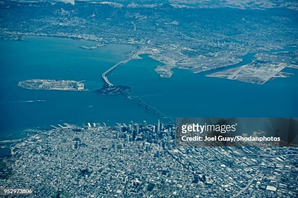high altitude high contrast san francisco downtown and bay bridge looking towards alameda and the foothills beyond 2 - alameda california stock pictures, royalty-free photos & images
