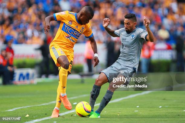 Enner Valencia of Tigres and Jonathan Urretaviscaya of Monterrey fight for the ball during the 17th round match between Tigres UANL and Monterrey as...