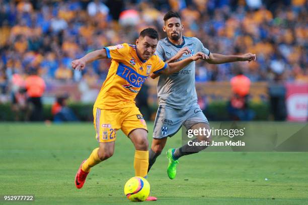 Alberto Acosta of Tigres and Jonathan Urretaviscaya of Monterrey fight for the ball during the 17th round match between Tigres UANL and Monterrey as...