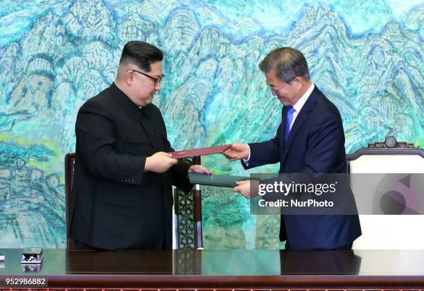 North Korea's leader Kim Jong Un and South Korea's President Moon Jae-in exchange documents during a signing ceremony near the end of their historic...