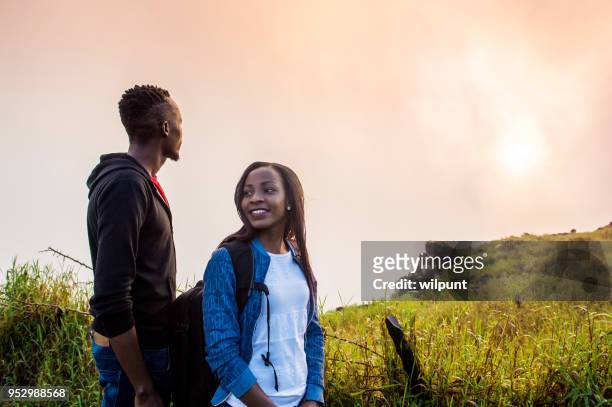 african couple looking in different directions - victoria falls stock pictures, royalty-free photos & images