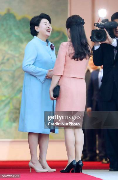 Ri Sol Ju , wife of North Korea's leader Kim Jong Un, is greeted by Kim Jung-sook , wife of South Korea's President Moon Jae-in, during the...