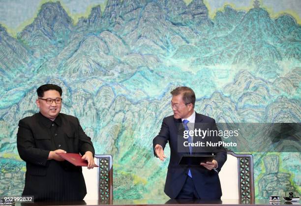 North Korea's leader Kim Jong Un and South Korea's President Moon Jae-in exchange documents during a signing ceremony near the end of their historic...