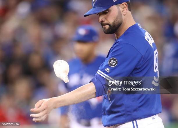 Jaime Garcia of the Toronto Blue Jays tosses the rosin bag up and down after giving up two home runs in the second inning during MLB game action...