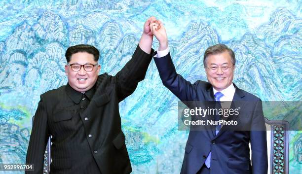 North Korea's leader Kim Jong Un and South Korea's President Moon Jae-in pose during a signing ceremony near the end of their historic summit at the...