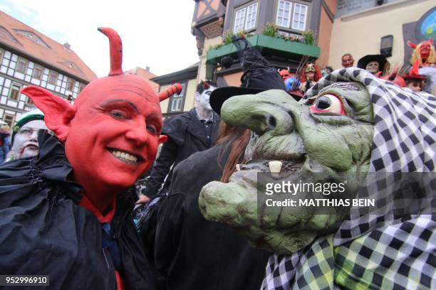 People dressed as devils ans witches pose on the market square of Wernigerode, central Germany, on April 30 as they celebrate the so-called Walpurgis...