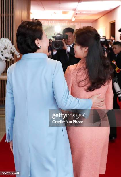 Ri Sol Ju , wife of North Korea's leader Kim Jong Un, is greeted by Kim Jung-sook , wife of South Korea's President Moon Jae-in, during the...