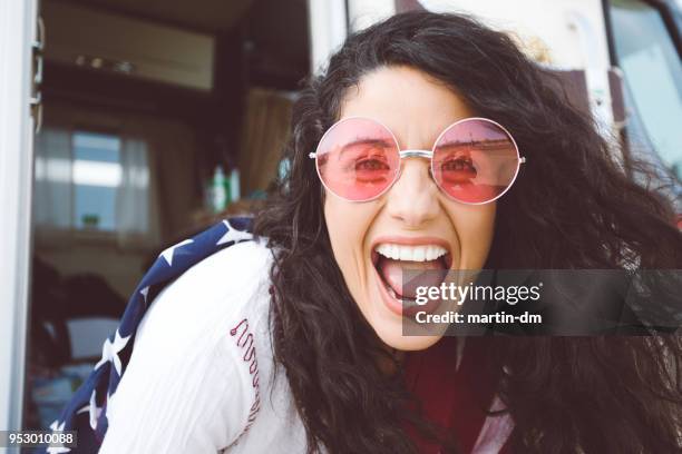 looking at world through rose colored glasses - female laughing face stock pictures, royalty-free photos & images