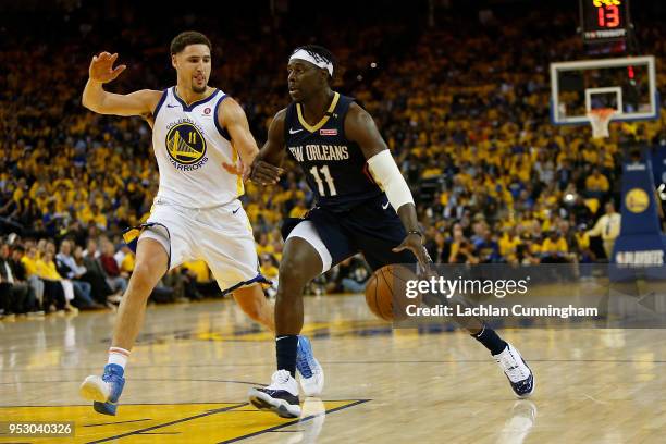 Jrue Holiday of the New Orleans Pelicans is guarded by Klay Thompson of the Golden State Warriors during Game One of the Western Conference...