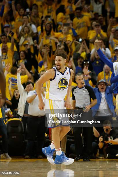 Klay Thompson of the Golden State Warriors reacts after making a three-point shot during Game One of the Western Conference Semifinals against the...